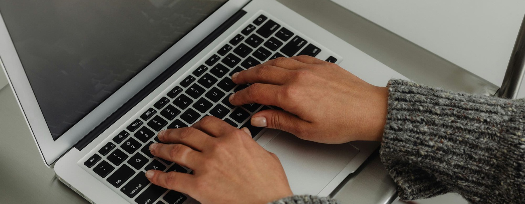 A person typing on a laptop