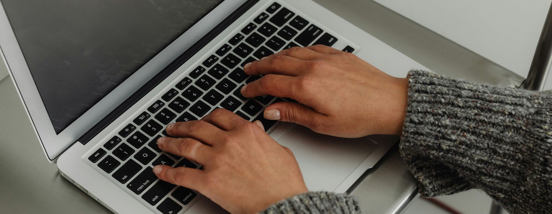 A person typing on a laptop